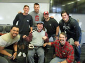 Danny is surrounded by the two teams who worked with him