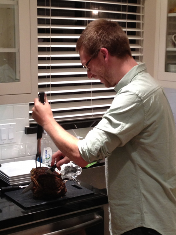 Photo of a person carving a prime rib