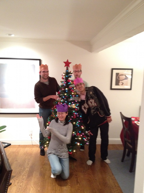 Photo of a group of people by a Christmas tree