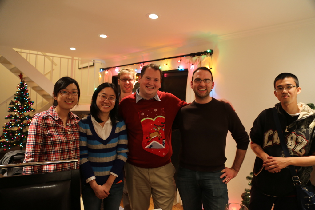 Photo of a group of people by a Christmas tree