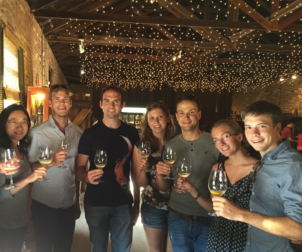 Photo of a group of people holding wine glasses