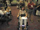 Linda Petty checks out a powered wheelchair
