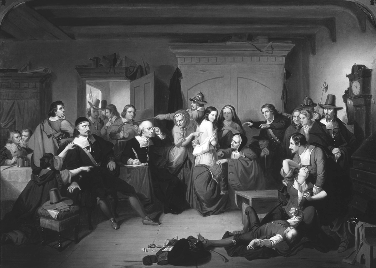 This 1853 oil painting by Tompkins Harrison Matteson title The Examination of a Witch depicts a dramatic scene with people in black garments, white collars, and tall hats. At the center, several figures in dark clothing appear to be examining or confronting women in lighter dress, including one in white and another in red. A man lies on the floor in the foreground.