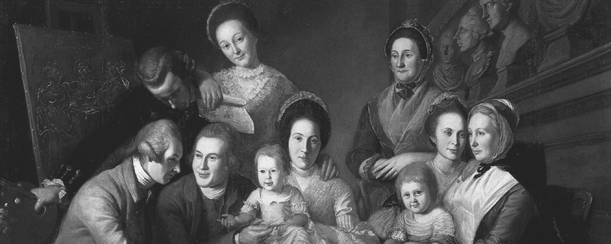 This late eighteenth-century oil portrait by Charles Willson Peale shows his well-dressed colonial American family gathered around a green table with fruit. The scene includes multiple generationsâ€”men, women, and childrenâ€”with a dog at their feet and classical architectural elements in the background.