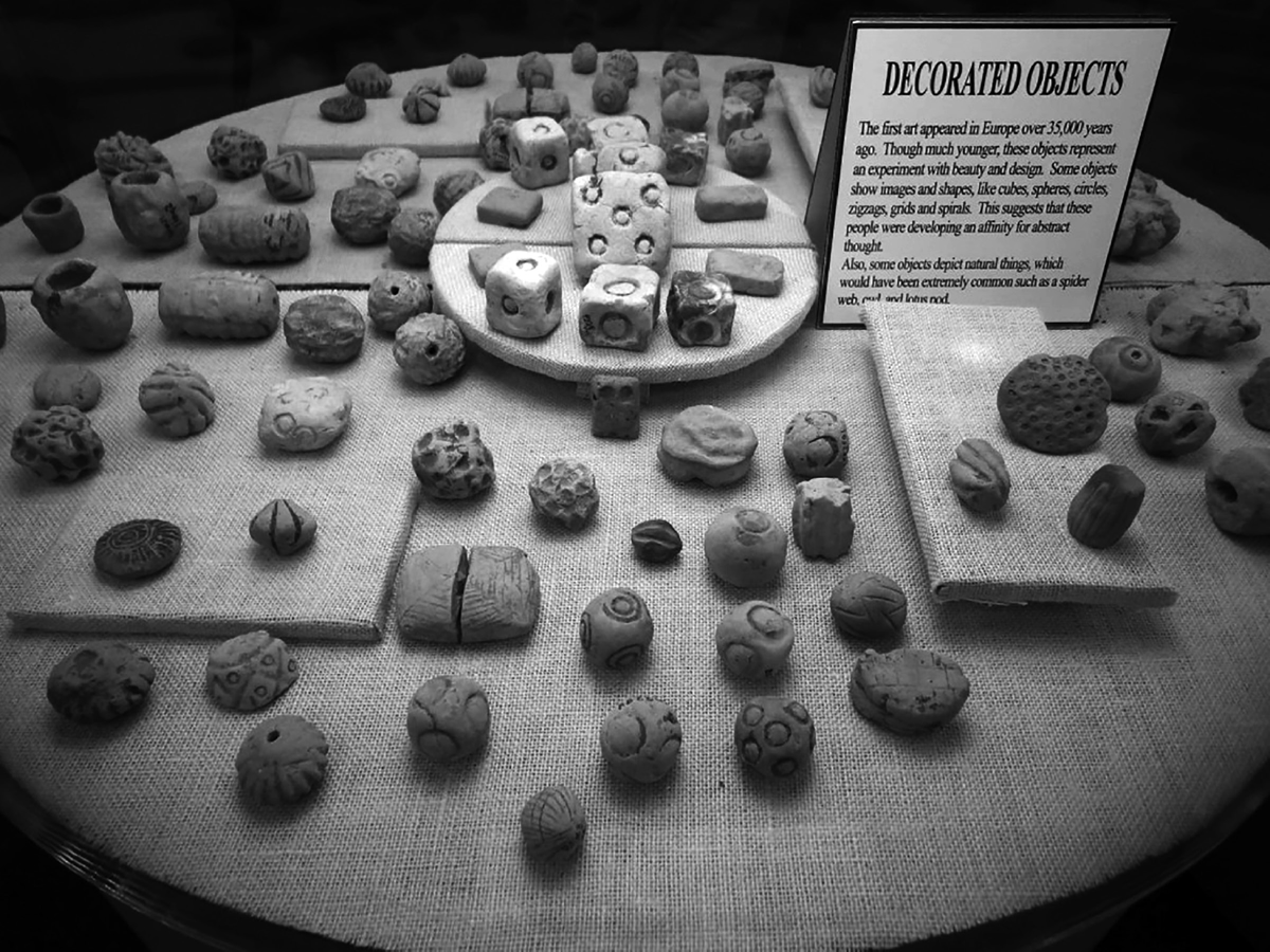 These small decorative clay objects are representative of the earliest artifacts discovered from Poverty Point, Louisiana. Spherical or geometric in shape, these clay fired objects are thought to have been used as artificial cooking stones.