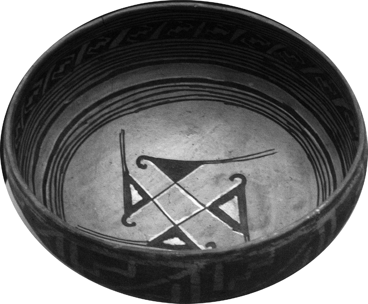 A fourteenth-century fired clay ancestral Hopi bowl from Navajo County, Arizona, is beautifully decorated with a geometric pattern along the rim and stylized birds in a circle in the center of the bowl connected to a diamond shape.