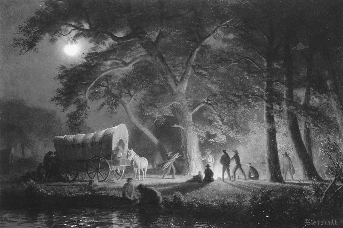 Albert Bierstadtâ€™s 1863 Oregon Trail (Campfire) is a nineteenth-century romantic landscape painting depicting a nighttime scene along the Oregon Trail. The image shows a covered wagon marked â€œOregonâ€ beside a dramatic campfire under large, gnarled trees, with a bright moon at upper left. Silhouetted figures gather around the fire, with horses nearby.