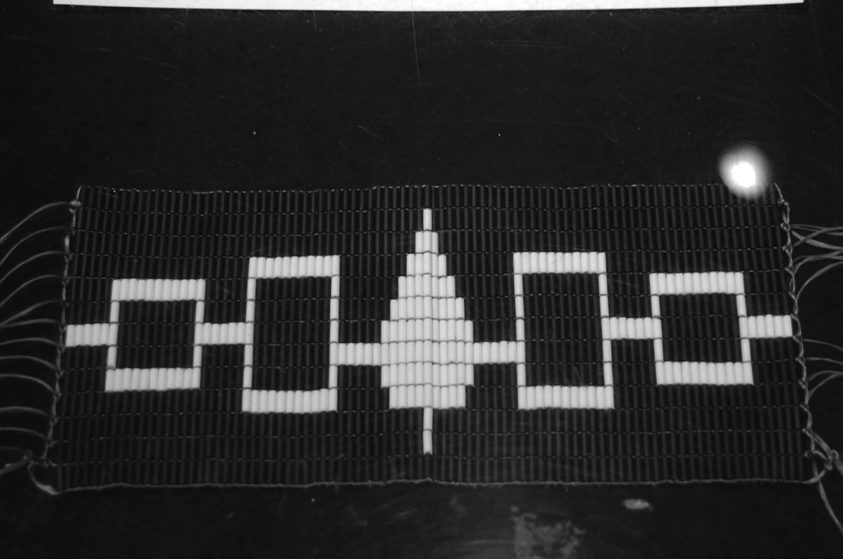 This belt, known as the Hiawatha Belt, symbolizes the unity of the five original Haudenosaunee nations. The belt is made of dark blue color leather and it is decorated with traditional shell beads or wampum used by many Eastern Woodlanders. Each tree or square is made of wampum and represents a tribe of the original five nations, and the line connecting them represents the path of peace.