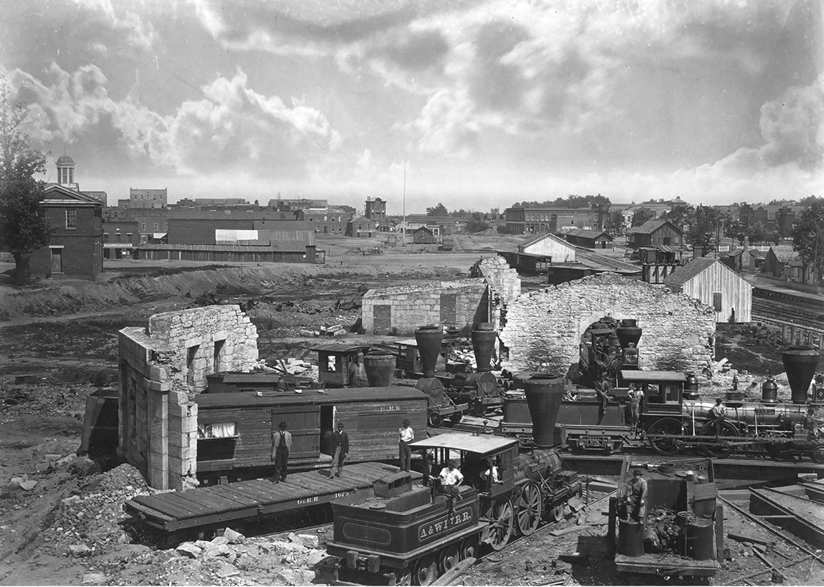 A 1866 photograph by George N. Barnard of destroyed buildings and railroad cars in Atlanta, Georgia.
