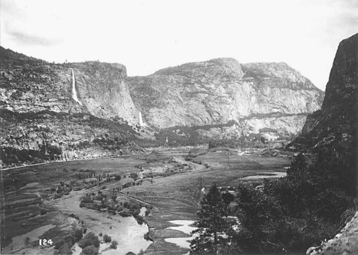 A small river winds its way through mountain cliffs.