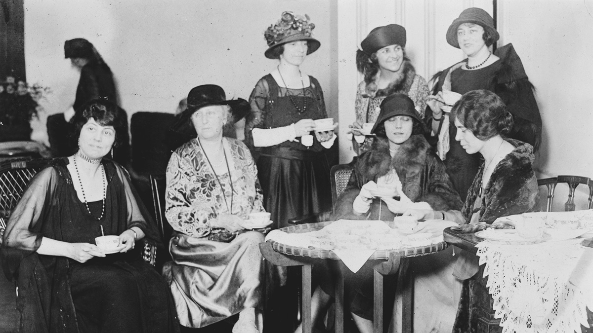 Women sit and drink tea.