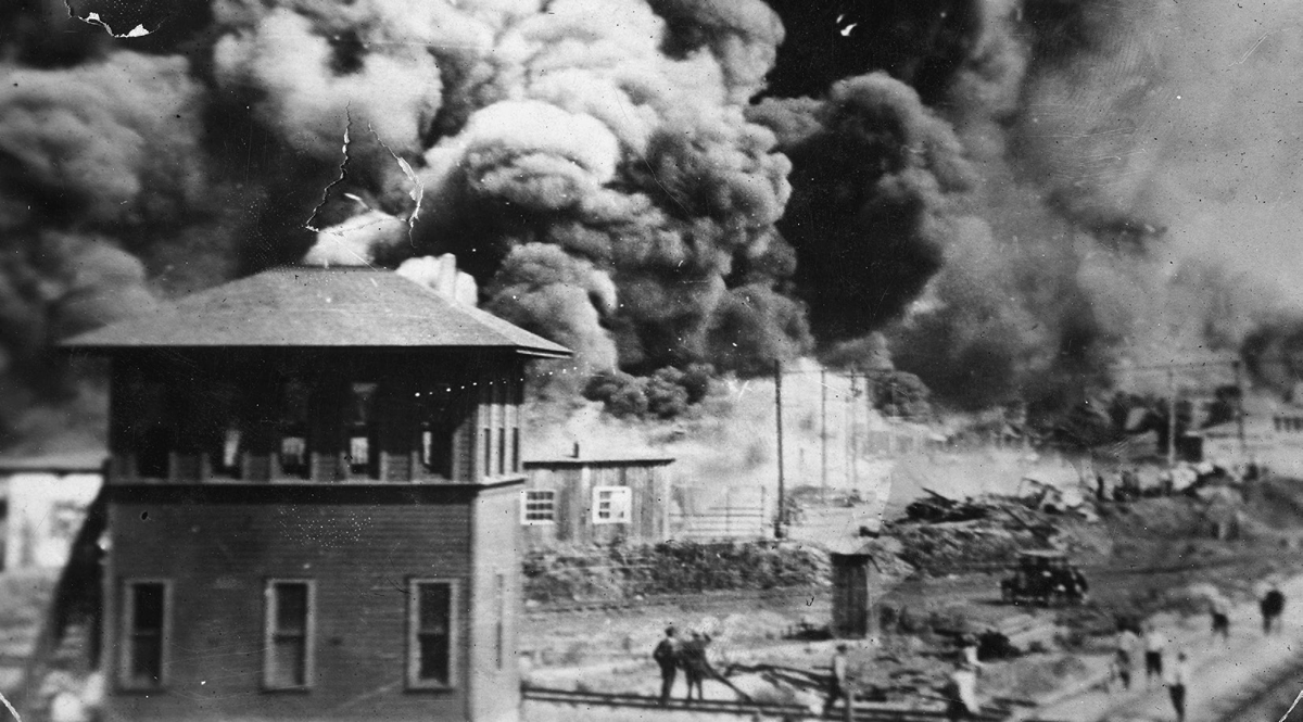 Fires burn in a city.
