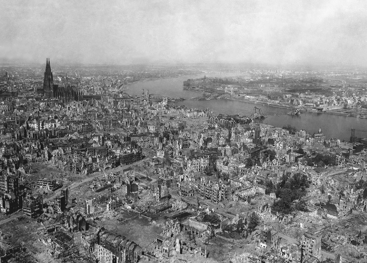 A large scene of destroyed buildings in a bombed-out city.