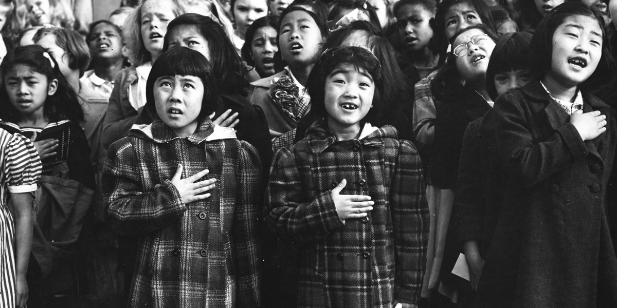 American children of Japanese descent in San Francisco recite the Pledge of Allegiance.