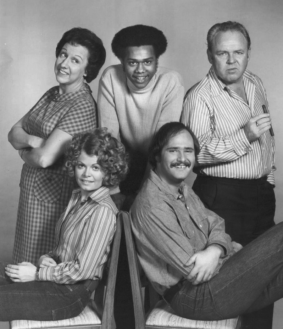 A publicity still showing five actors from the cast of CBSâ€™s All in the Family posing for the camera.