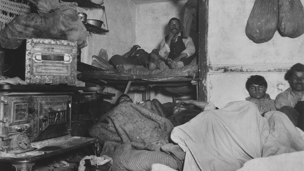 Several men attempting to rest in an overcrowded room.