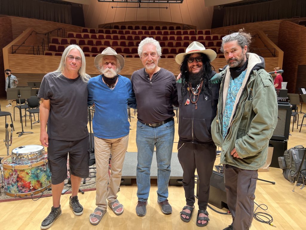 Bob Weir stands arm-in-arm with Jeff Chimenti, Paul Phillips, Don Was, and Jay Lane in Bing Concert Hall at Stanford University