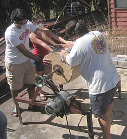 Sanding While Two People Hold Barrel