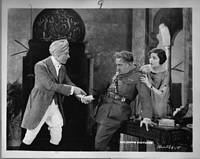 George Arliss threatens Harry T. Morey as Alice Joyce looks on